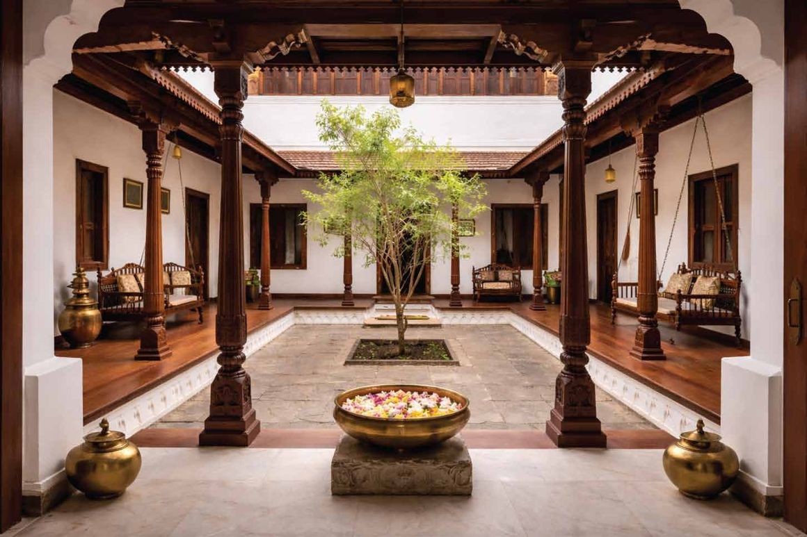 Old Madras – earthen courtyard with carved wooden pillars and an oonjal (artist's impression)
